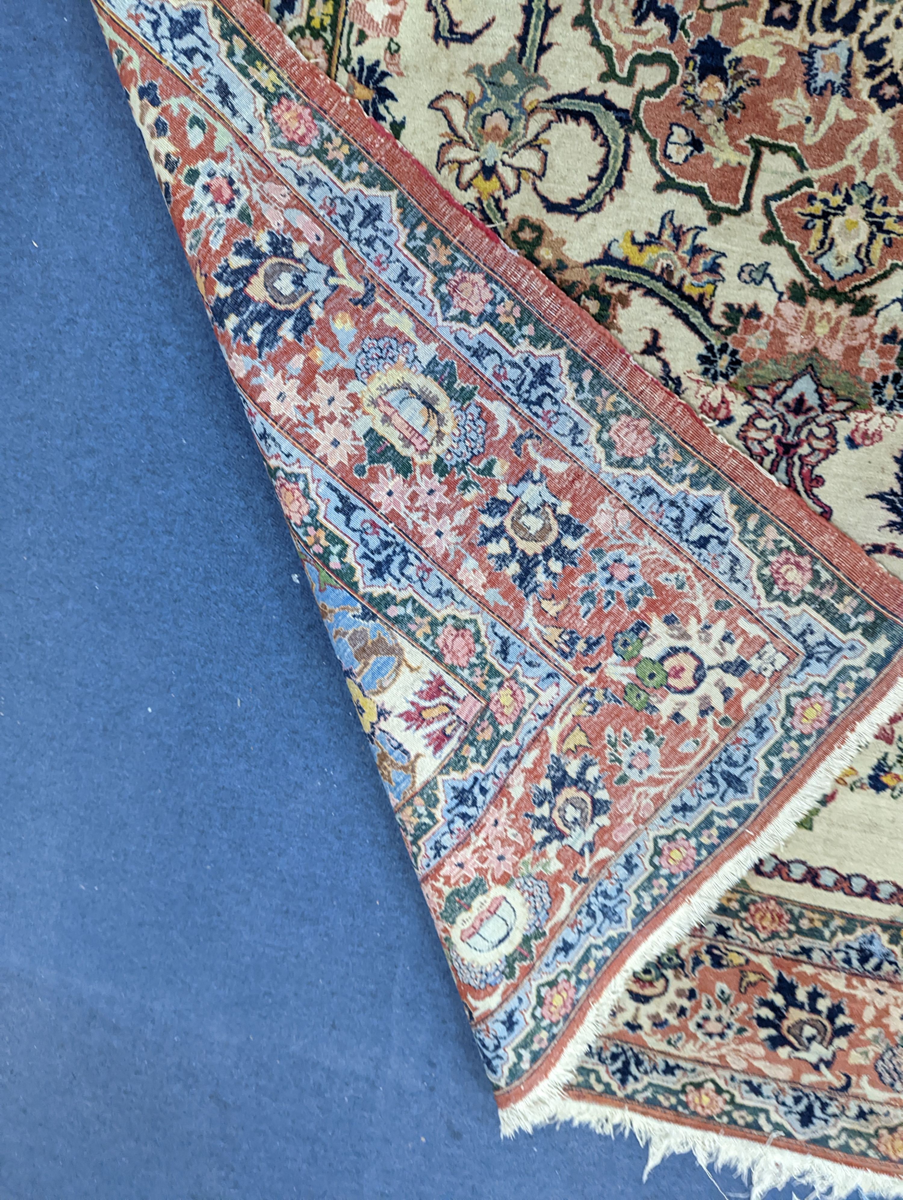 A part silk Isfahan cream rug with central floral scroll medallion, 196 x 140cm